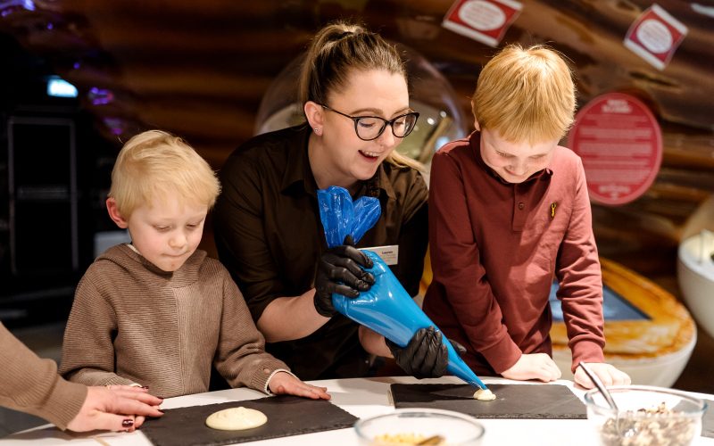 Children preparing for chocolate lolly making
