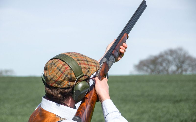 A man with shotgun clay pigeon shooting