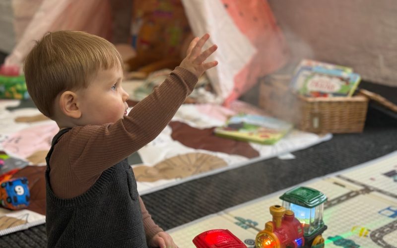 Playing with toy steam train - Adam Lewis